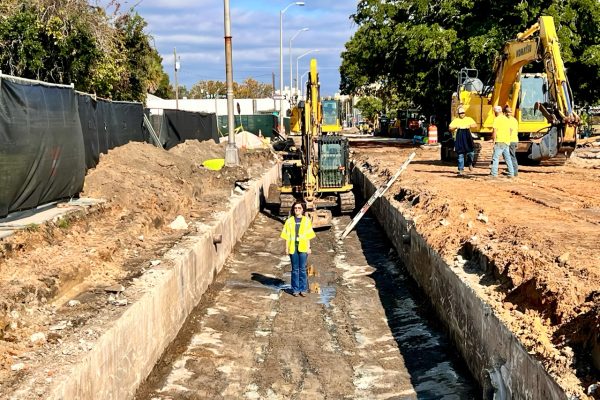 What's under our streets? Jennifer Greene stands in the now-exposed box culvert that runs under much of St Louis Street.